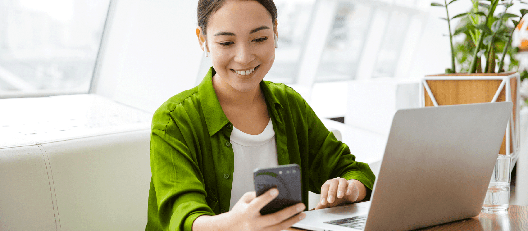 Woman Working on Her Phone and Laptop | Capital Funds Investments (CFI)